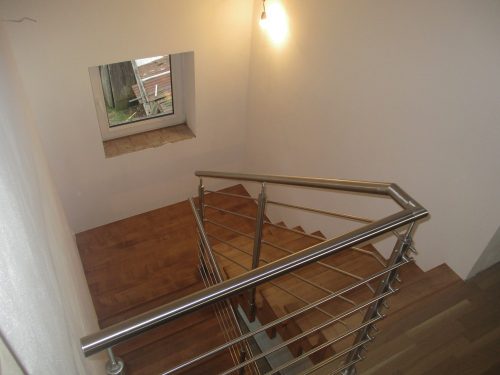 Dřevěné schodiště s kovovým zábradlím